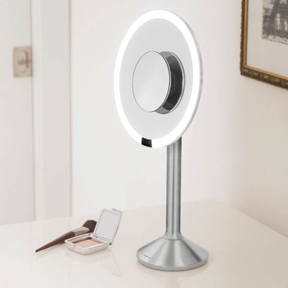 sensor mirror pro round - brushed finish - lifestyle on counter with cosmetics